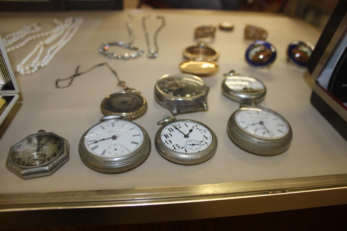 Antique pocket watches and jewelry laid out for personal property appraisal in Franklin County PA